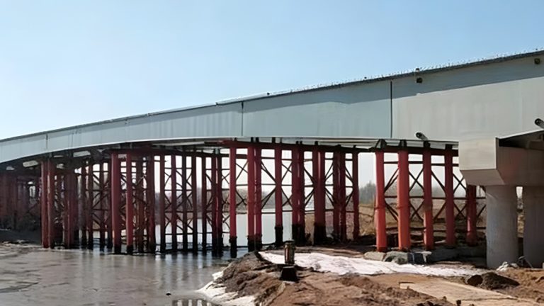 Heavy-duty steel box girder bridge under construction with red structural supports and light gray box sections by Shijie Heavy Industry