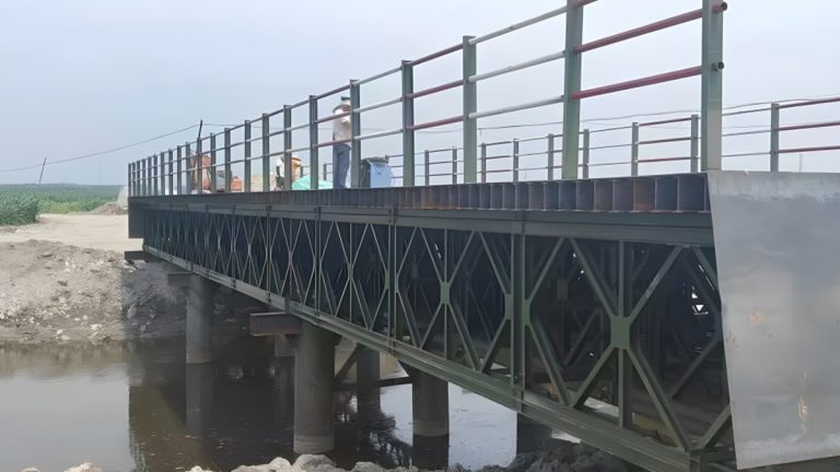 Modular steel Bailey bridge with diamond truss panels and safety railings under construction by Shijie Heavy Industry