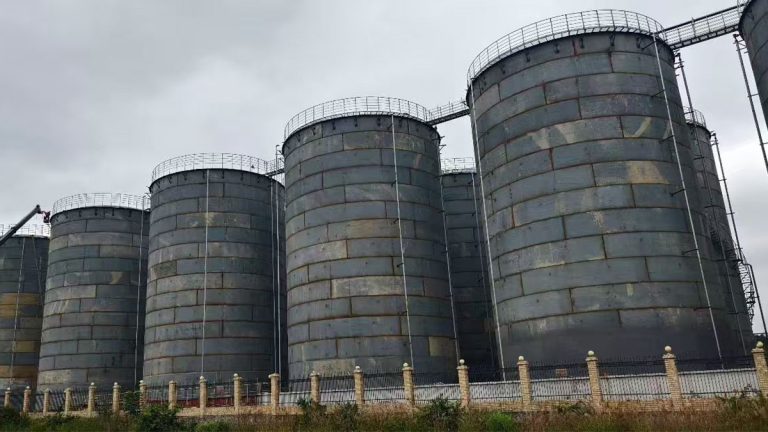 Cluster of large field-erected vertical steel storage tanks with top railings by Shijie Heavy Industry