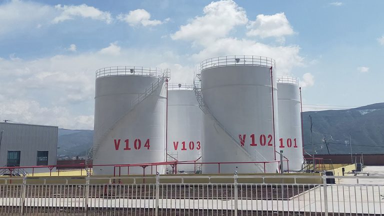 Row of large white vertical industrial storage tanks with spiral staircases and red identification numbers by Shijie Heavy Industry