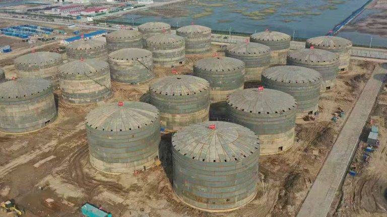 Large white vertical industrial storage tank with integrated spiral staircase and safety platform by Shijie Heavy Industry